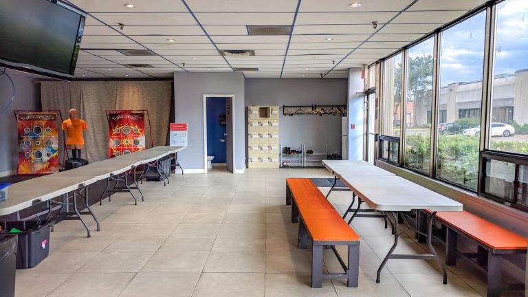 View of lounge, including main eating area and tables for food/goody bags/setting up